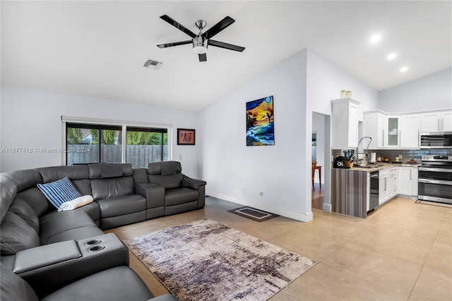 living room featuring ceiling fan, sink, and high vaulted ceiling