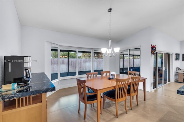 dining room featuring lofted ceiling and a chandelier