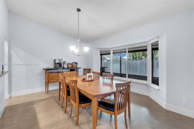 dining space featuring a chandelier and vaulted ceiling