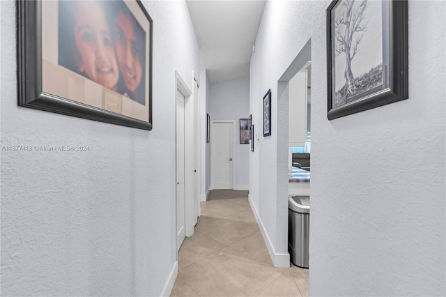 hall with light tile patterned floors