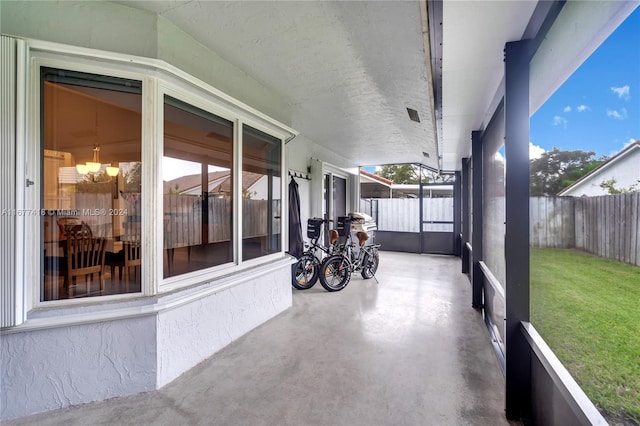 unfurnished sunroom featuring a notable chandelier