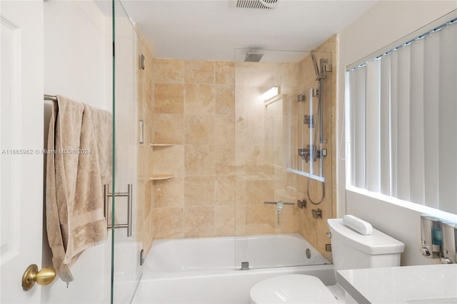 full bathroom featuring vanity, toilet, and enclosed tub / shower combo