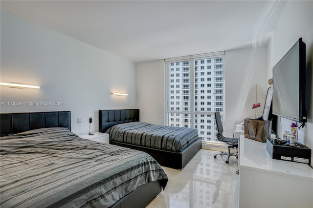 tiled bedroom with floor to ceiling windows