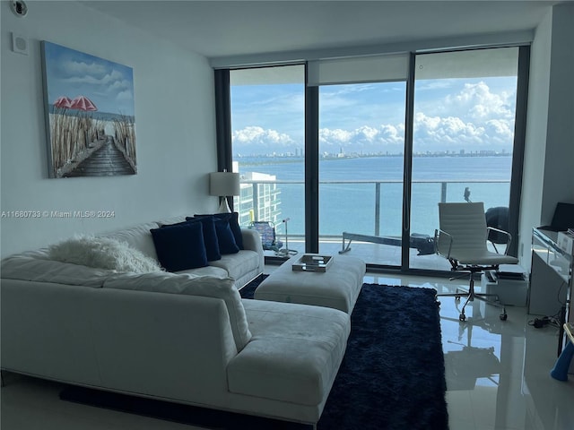 living room with floor to ceiling windows and a water view