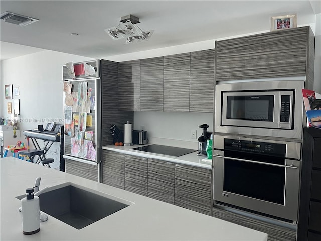 kitchen with appliances with stainless steel finishes and sink