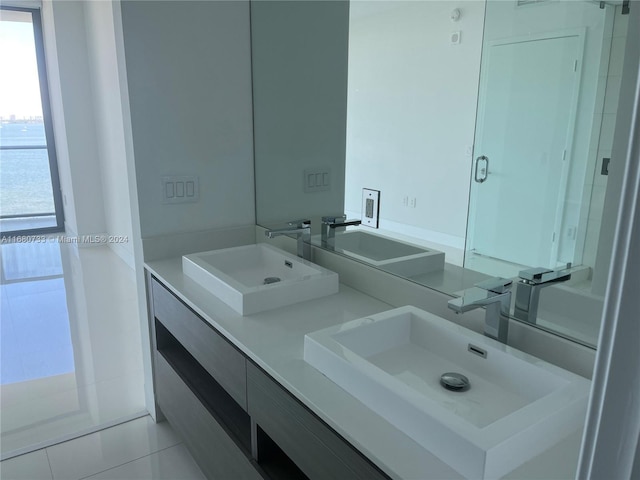 bathroom featuring vanity, an enclosed shower, and tile patterned flooring