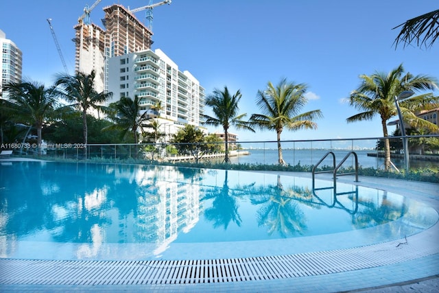 view of swimming pool with a water view