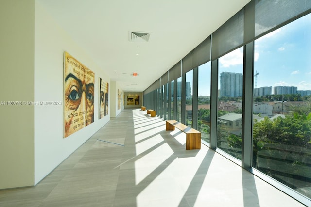 hall featuring floor to ceiling windows