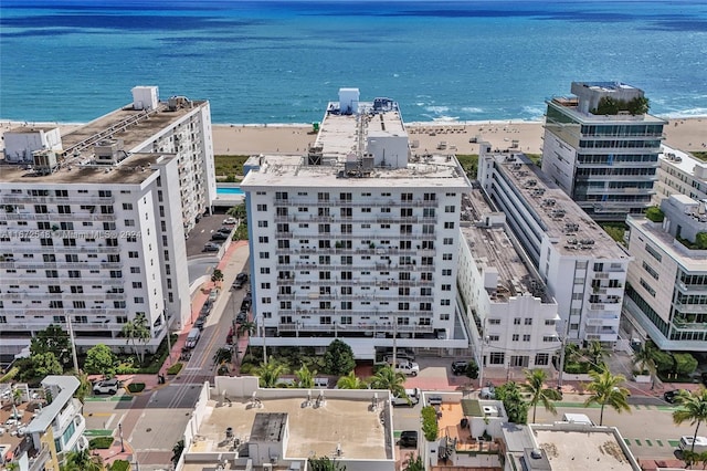 birds eye view of property with a water view and a view of the beach