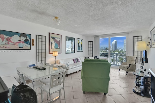 living room featuring light tile patterned flooring and a textured ceiling