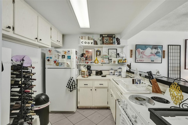 kitchen with light tile patterned floors and white appliances