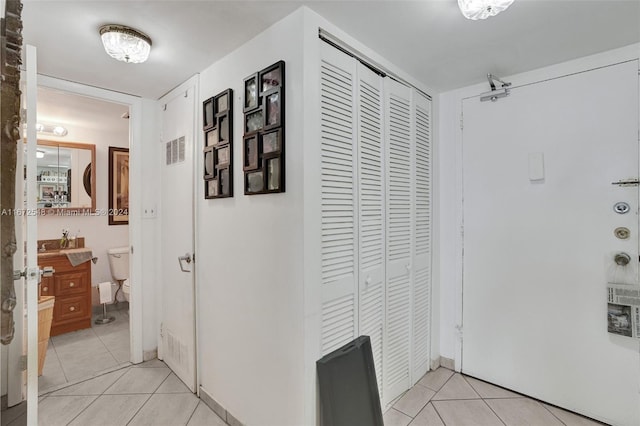 hallway featuring light tile patterned flooring