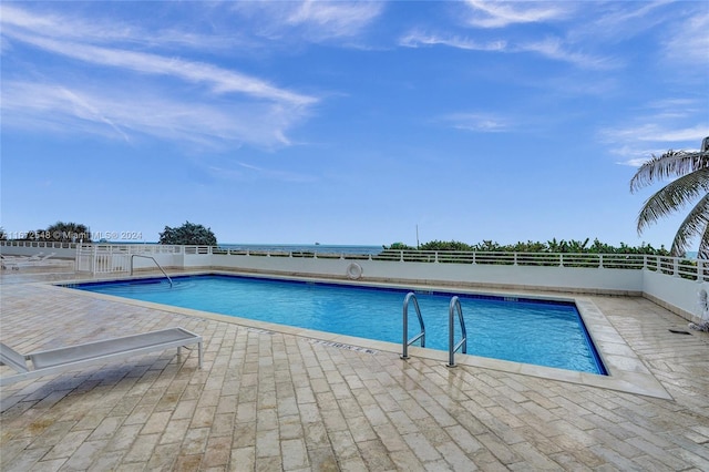 view of swimming pool featuring a patio area