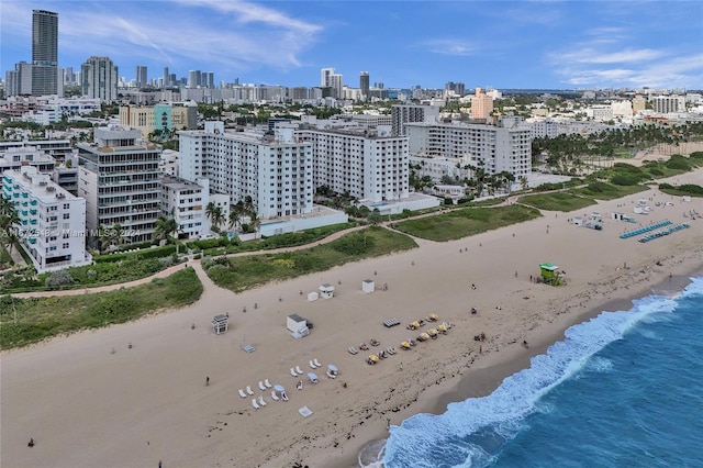 birds eye view of property featuring a view of the beach and a water view