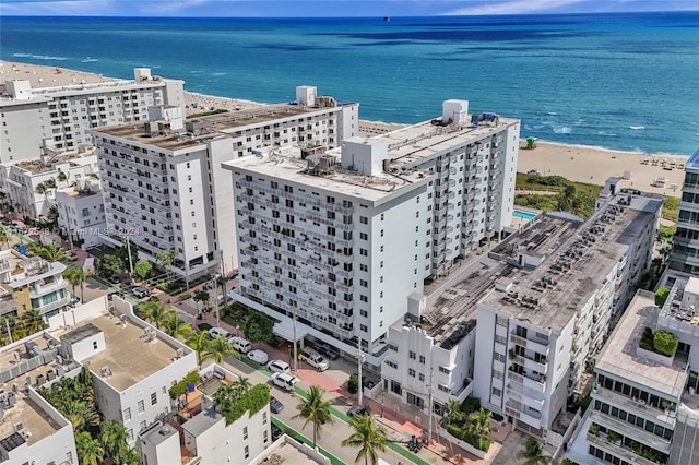 drone / aerial view with a beach view and a water view