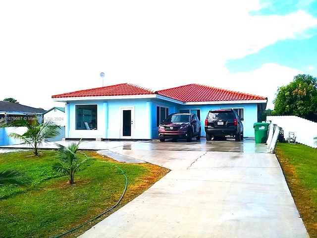 rear view of house featuring a garage and a yard