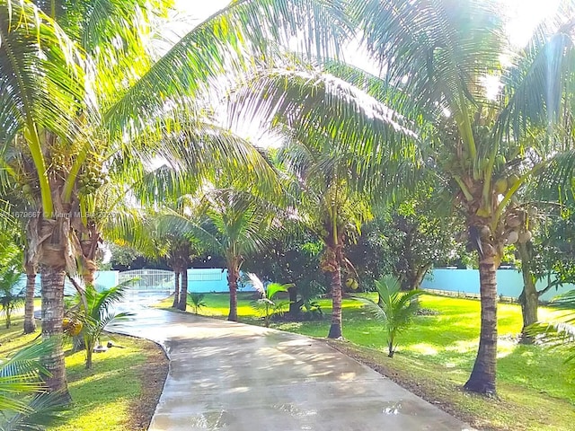 surrounding community featuring a yard and fence