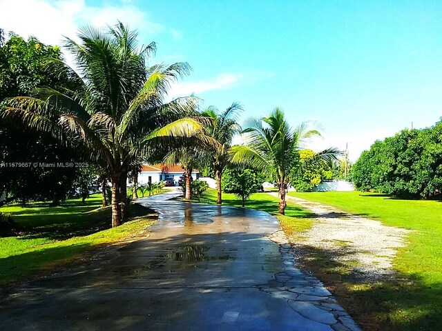 view of community with a lawn and a water view