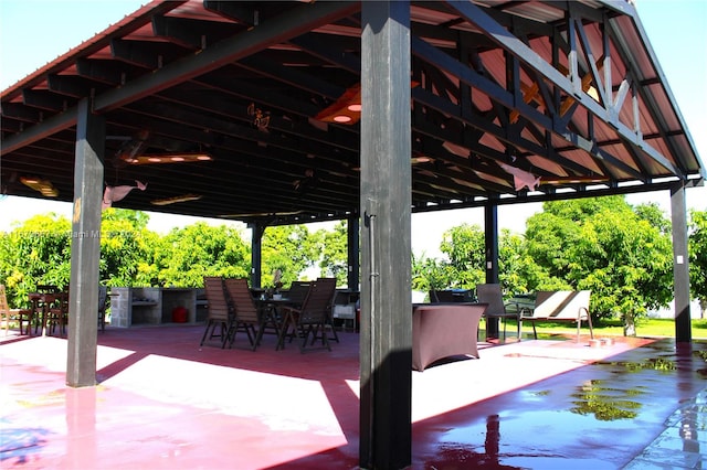 view of patio with area for grilling and an outdoor bar