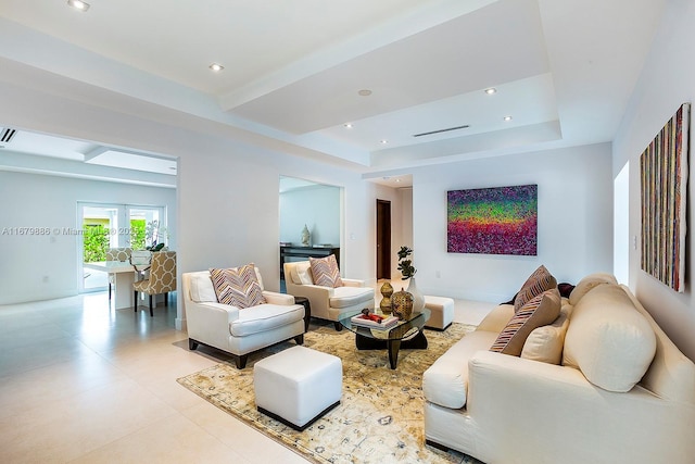 living room featuring a tray ceiling