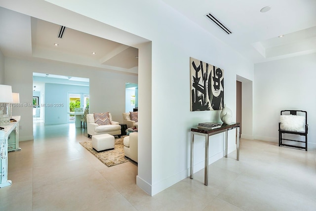 hallway with a raised ceiling