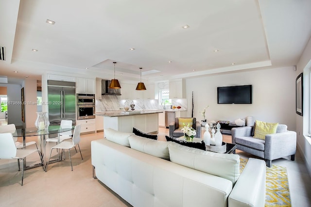 living room with a tray ceiling