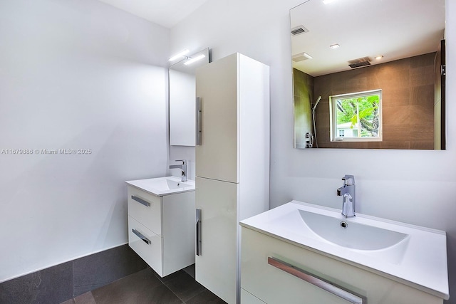 bathroom with tile patterned flooring and vanity