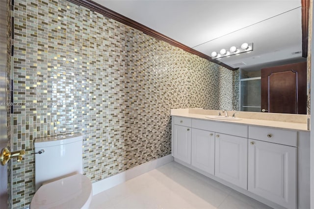 bathroom featuring vanity, a shower with door, toilet, ornamental molding, and tile walls