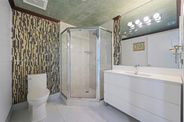 bathroom featuring tile patterned flooring, vanity, toilet, and an enclosed shower