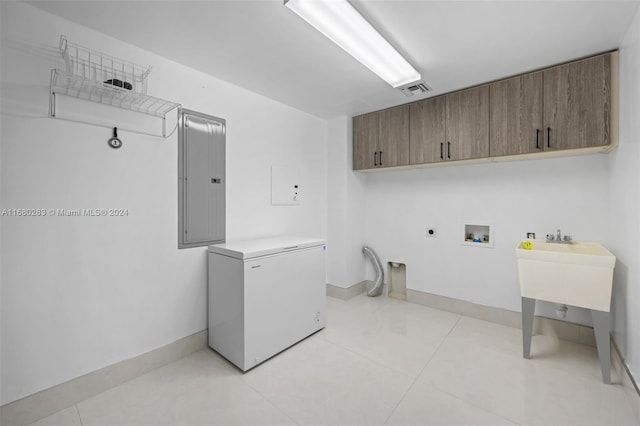 clothes washing area with electric dryer hookup, cabinets, electric panel, hookup for a washing machine, and light tile patterned floors