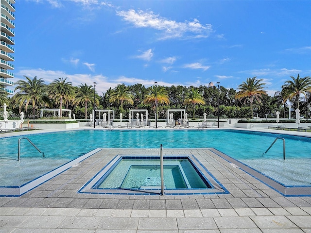 view of pool featuring a patio area and a community hot tub