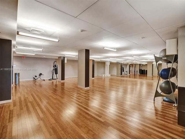 exercise room featuring light wood-type flooring