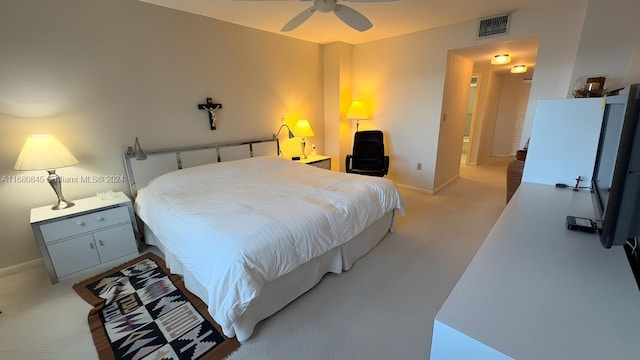 bedroom featuring light colored carpet and ceiling fan