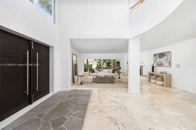 foyer entrance featuring a towering ceiling