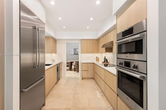 kitchen featuring light tile patterned floors, light brown cabinetry, decorative backsplash, and stainless steel appliances