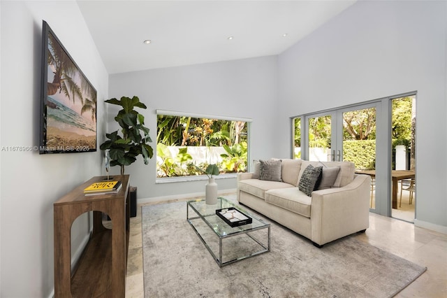 living room with french doors and a high ceiling