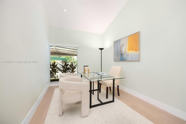 dining space with lofted ceiling and wood-type flooring