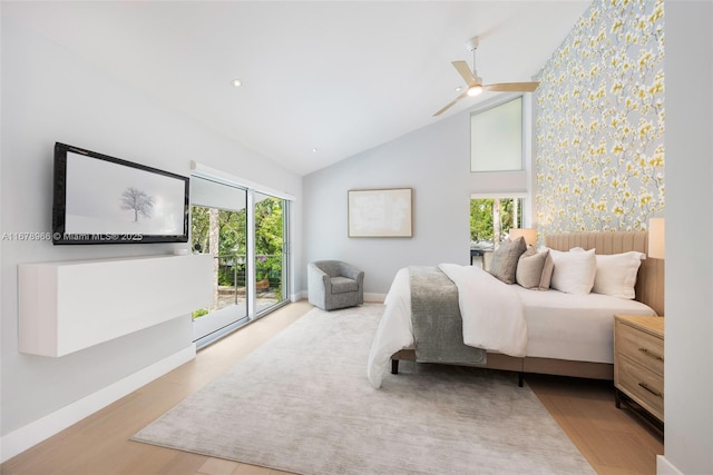 bedroom with ceiling fan, access to exterior, light hardwood / wood-style flooring, and multiple windows