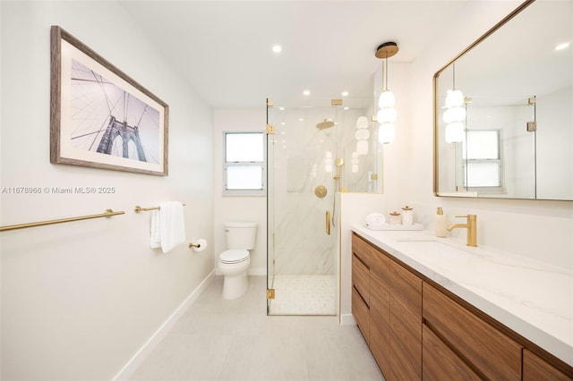 bathroom with a shower with shower door, vanity, tile patterned floors, and toilet