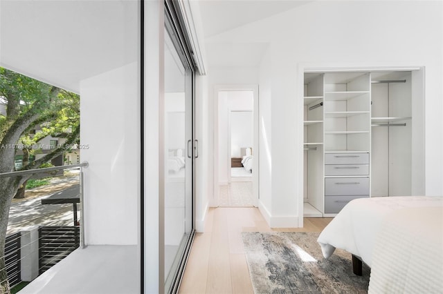 bedroom with light wood-type flooring and multiple windows