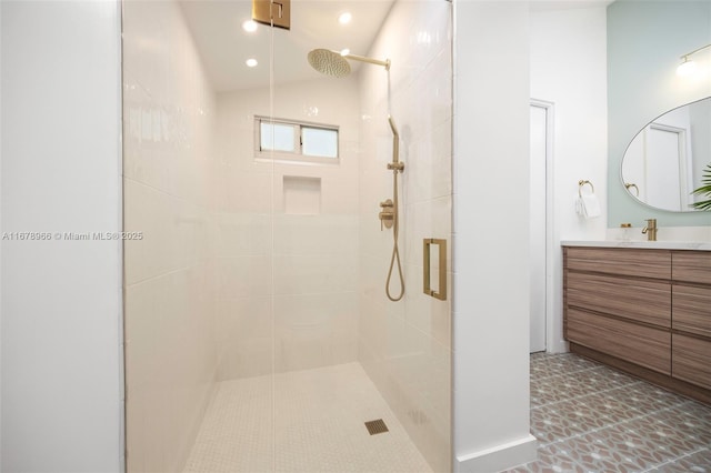 bathroom featuring walk in shower, lofted ceiling, and vanity