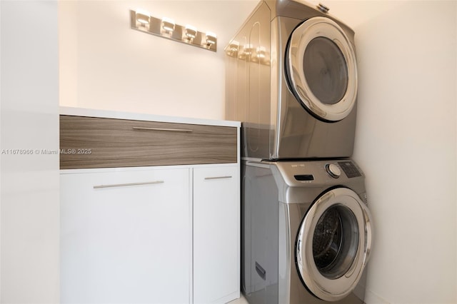 clothes washing area with stacked washer / dryer