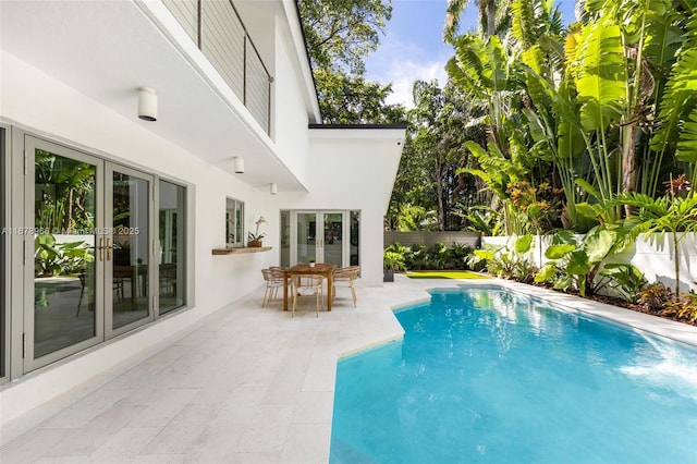 view of swimming pool featuring french doors and a patio area