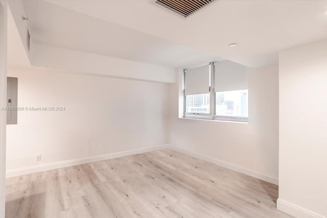 unfurnished room with light wood-type flooring