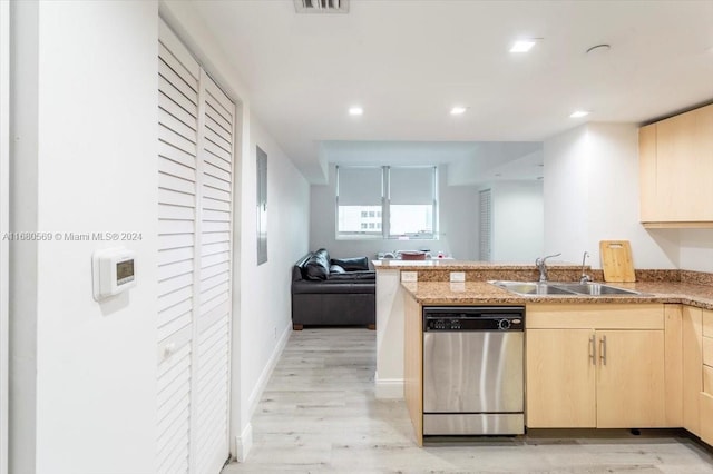 kitchen with dishwasher, kitchen peninsula, sink, light brown cabinetry, and light hardwood / wood-style floors