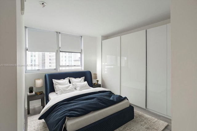 bedroom with a closet and light hardwood / wood-style floors