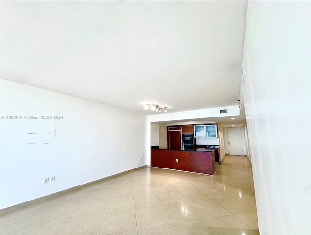 unfurnished living room featuring light tile patterned floors