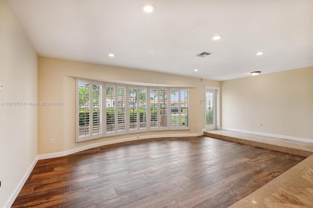 spare room featuring dark wood-type flooring