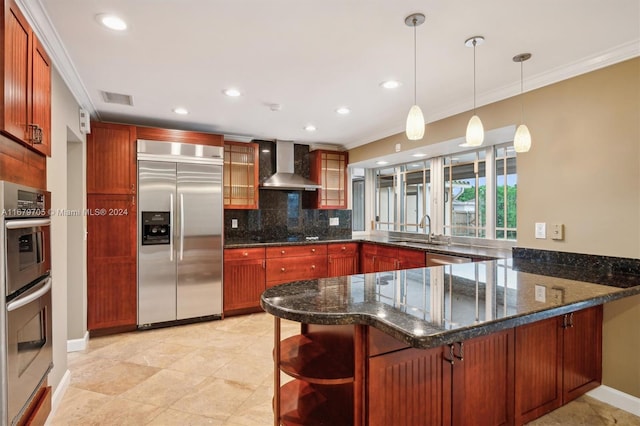 kitchen with a kitchen breakfast bar, wall chimney exhaust hood, stainless steel appliances, and kitchen peninsula