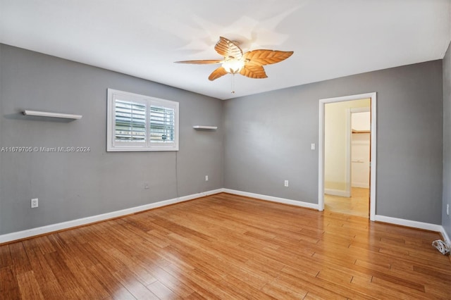 empty room featuring light wood-type flooring and ceiling fan